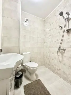 a bathroom with a toilet and a sink and a shower at Spacious 1BR Apartment in Central Sofia, Next to University in Sofia