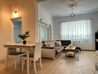 a living room with a couch and a table at Spacious 1BR Apartment in Central Sofia, Next to University in Sofia