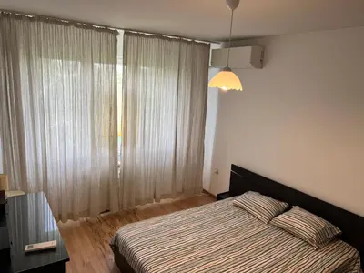 a bedroom with a bed and a large window at South Park in Sofia