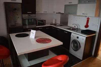 a kitchen with a counter and a washing machine at Pirin 7 in Pazardzhik