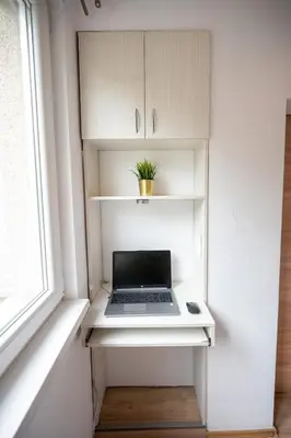 a laptop sitting on a shelf in a room with a window at Spacious 1BDR in the Center with FREE Parking in Sofia