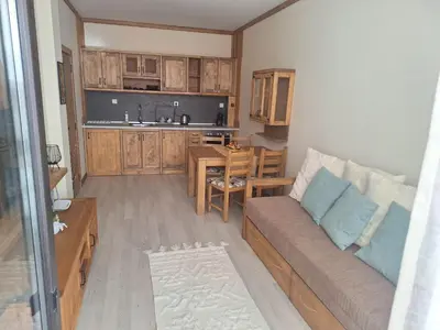 a living room with a couch and a kitchen at Ego apartment Velingrad in Velingrad