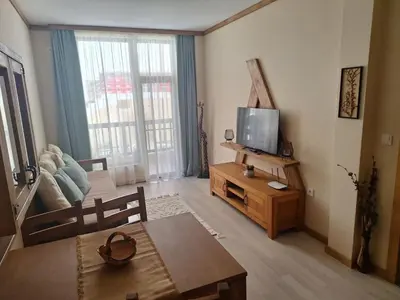 a living room with a television and a table at Ego apartment Velingrad in Velingrad