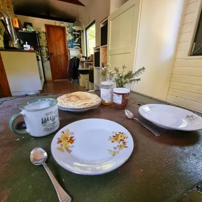 a table with plates and spoons on top of it at Bendji Land - vacation hideaway, close to Sofia in Ribarica