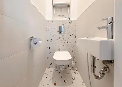 a small bathroom with a toilet and a sink at Stylish 2BD with Balcony & Desk near Vitosha Blvd by Flat Mаnager in Sofia