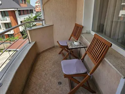 two chairs and a table on a balcony at Bright and spacious apartment with panoramic views in Sofia