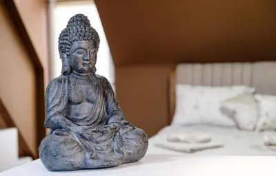 a statue sitting on a table next to a bed at Heart & Honey - The Romantic Loft in Plovdiv