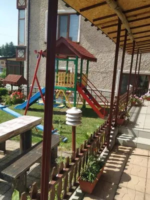a playground with a slide and a swing at Villa Silvinka in Dospat