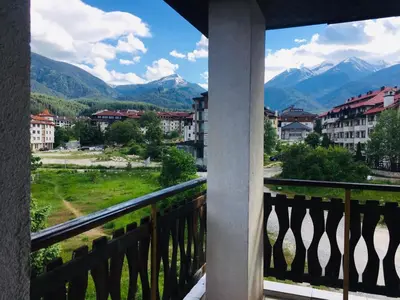 a balcony with a view of the mountains at Beautiful two bedroom 4th floor apartment in Elegant Luxe Hotel with pool, sauna, gym and steam room in Bansko