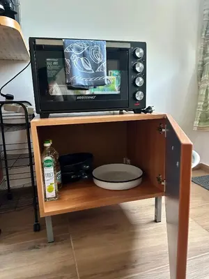 a microwave oven sitting on top of a table at Bright, City Centre, 1BR Apartment , Next to Sofia University in Sofia