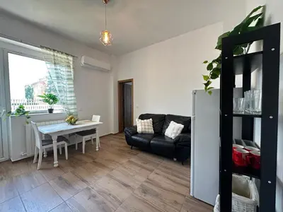 a living room with a black couch and a table at Bright, City Centre, 1BR Apartment , Next to Sofia University in Sofia