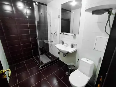 a bathroom with a shower and a toilet and a sink at Aspen Apartment A208 3OOm from Gondola in Bansko