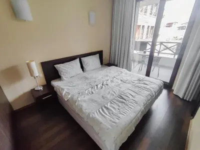 a bedroom with a large bed with a window at Aspen Apartment A208 3OOm from Gondola in Bansko