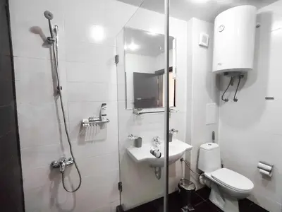 a bathroom with a shower and a toilet and a sink at Aspen Apartment A208 3OOm from Gondola in Bansko