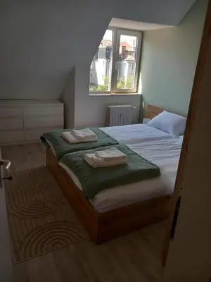 a bedroom with two beds with towels on them at the green apart in Sofia