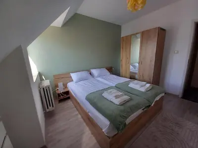 a bedroom with a bed with two towels on it at the green apart in Sofia