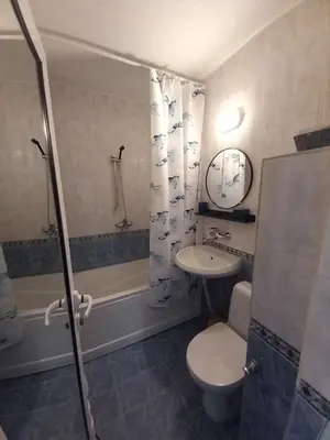 a bathroom with a toilet and a sink and a shower at the green apart in Sofia