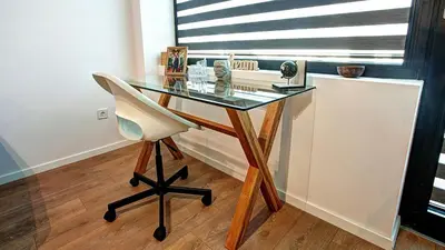 a glass desk with a chair in a room at College Flat - Wi-Fi with 600 Mbit speed in Sofia