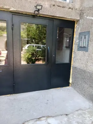 a black door with a window on a building at Apartament KETI улица Христо Максимов 56 вхВ in Sofia
