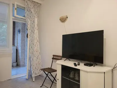 a living room with a flat screen tv on a white cabinet at Apartament KETI улица Христо Максимов 56 вхВ in Sofia