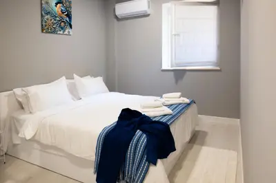 a bedroom with a bed with white sheets and a window at Top City Centre Apartment 122 in Sofia