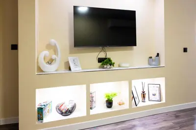 a living room with a tv on a wall at Top City Centre Apartment 122 in Sofia