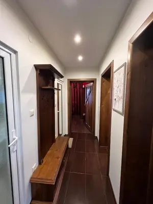 a hallway with a wooden bench in a house at Къща Добринище in Dobrinishte