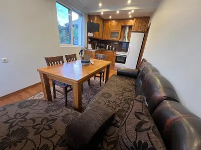 a living room with a couch and a wooden table at Къща Добринище in Dobrinishte