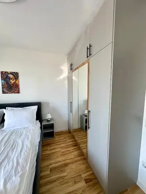 a bedroom with a bed and a closet and a door at D&G City Homes in Sofia