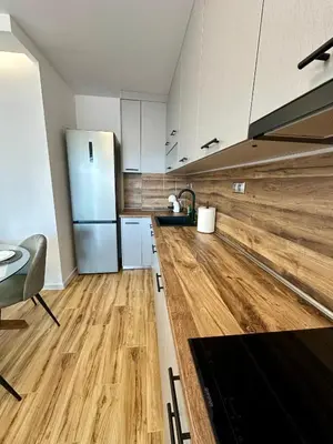 a kitchen with a wooden floor and a refrigerator at D&G City Homes in Sofia