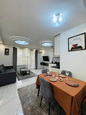 a dining room with a table and a living room at Top Central Apartment 2 in Sofia
