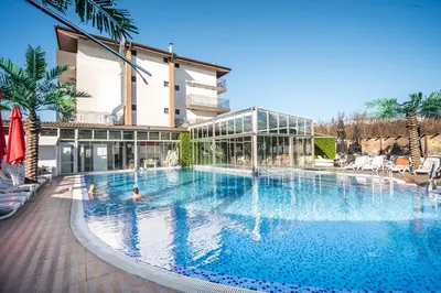 a large swimming pool in front of a building at Hotel Royal Bath in Banya