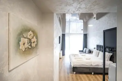 a bedroom with a bed and a painting on the wall at Hotel Royal Bath in Banya