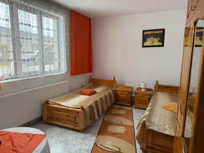a room with two beds and a window at Къща за гости Гаджо Gadjo in Bansko