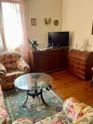 a living room with a coffee table and a tv at Aristocratic Top Central Apartment in Sofia