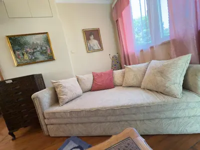 a living room with a couch with pillows on it at Aristocratic Top Central Apartment in Sofia
