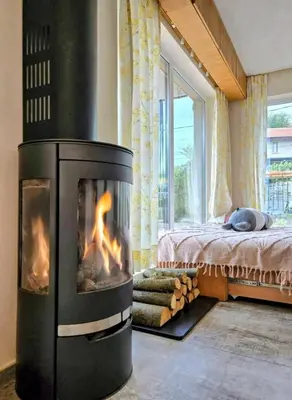 a fireplace in a room with a bed and a window at Ma-Bebe PlayHouse with Private Sauna --- Lake, Parks and SPA Pools in 5 min in Pancharevo