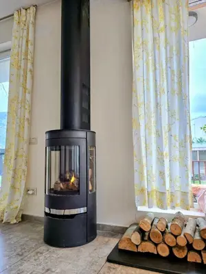 a fireplace in a living room with a pile of logs at Ma-Bebe PlayHouse with Private Sauna --- Lake, Parks and SPA Pools in 5 min in Pancharevo