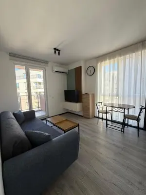a living room with a couch and a table at Stay Point One Bedroom Apartment Including Underground Parking Place in Sofia