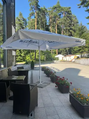 a white umbrella sitting on top of a patio at Chamkoria Forest View & Spa Apartment in Borovets