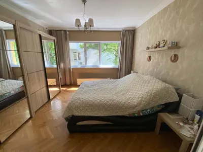 a small bedroom with a bed and a window at Journalist squad in Sofia