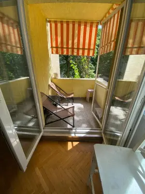 a screened in porch with a chair in a room at Journalist squad in Sofia