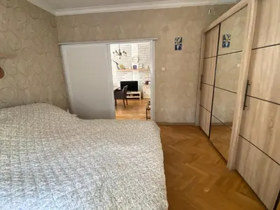 a bedroom with a bed and a desk in a room at Journalist squad in Sofia