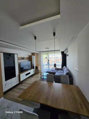 a living room with a table and a couch at Dilyanka 3 in Pernik
