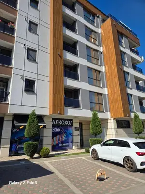 a white car parked in front of a building at Dilyanka 3 in Pernik