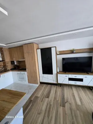 a large living room with a large flat screen tv at Dilyanka 3 in Pernik