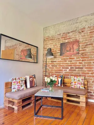 a living room with a couch and a brick wall at Boby Center Home in Sofia