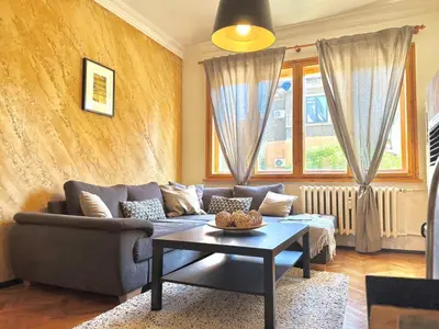 a living room with a couch and a table at Boby Center Home in Sofia