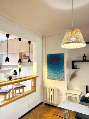 a kitchen and living room with a table and a dining room at Boby Center Home in Sofia