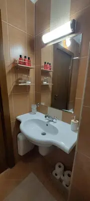 a bathroom with a white sink and a mirror at Nature Escape to Pirin Golf in Razlog